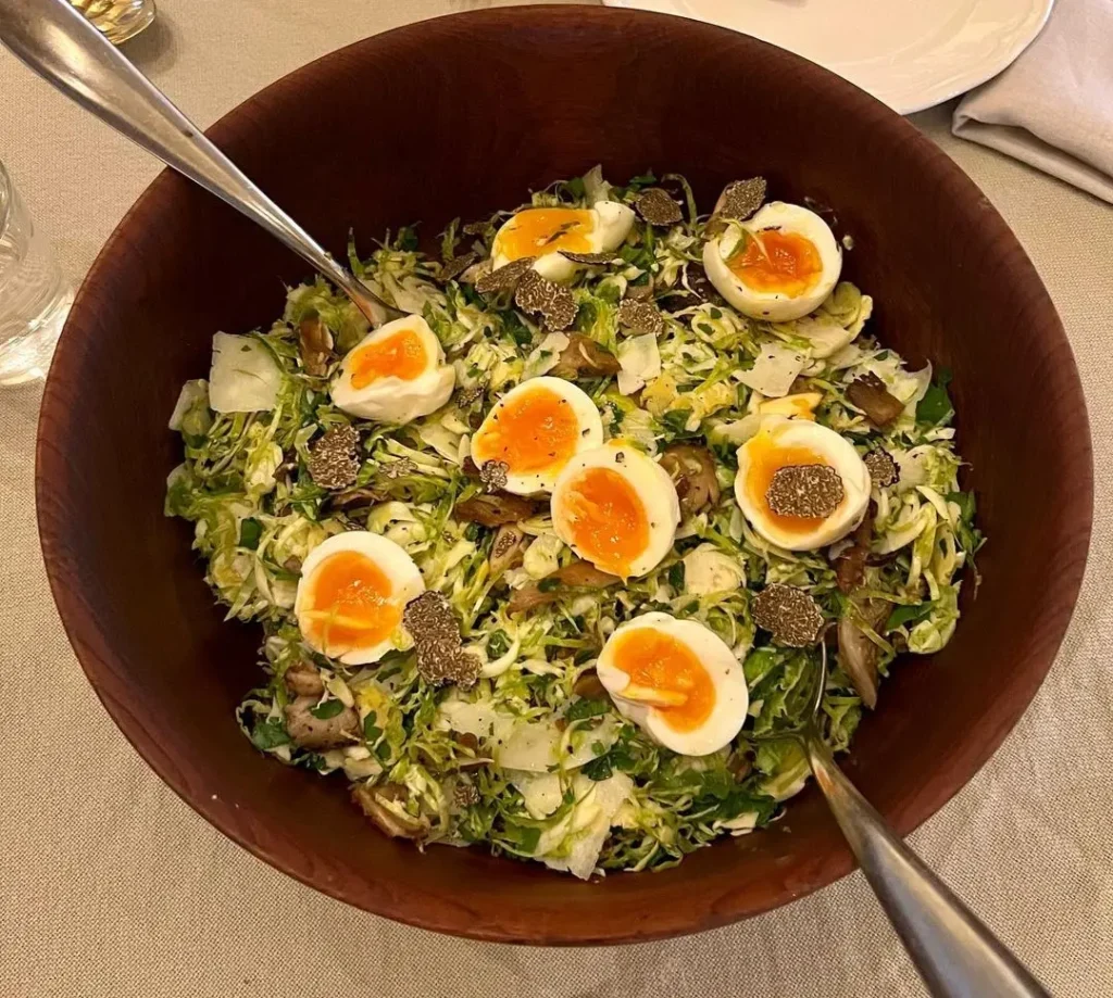 Raw Brussel sprout salad with mushrooms and truffled eggs.
